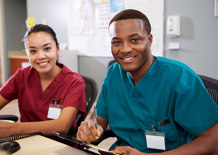 International nurses smiling with scrubs on
